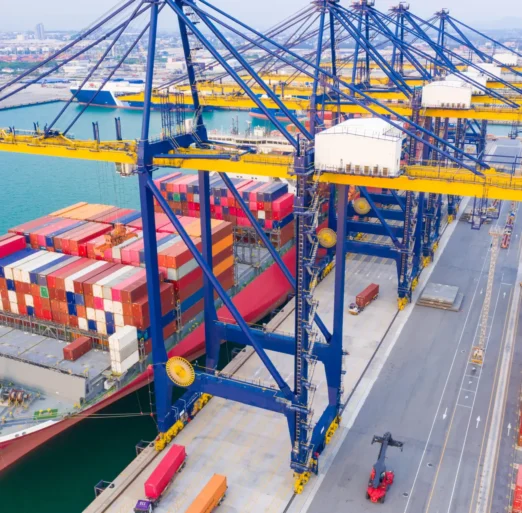 Container ships at industrial ports in the business of import, export, logistics and international maritime transport, loading of containers on cargo ships with cranes,
Transportation of goods by container trucks to customers.